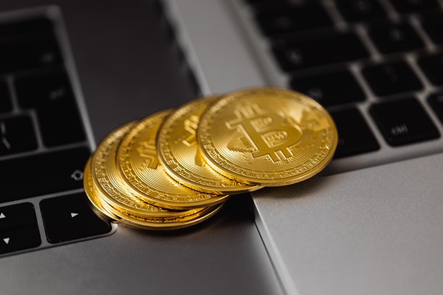 imagens de moedas, simbolizando dinheiro digital, em cima do teclado de notebook
